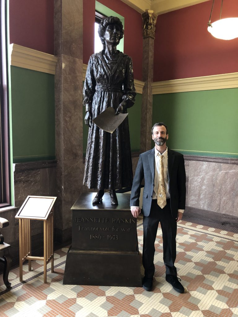 Image of Scott posing with Janette Rankin Statue